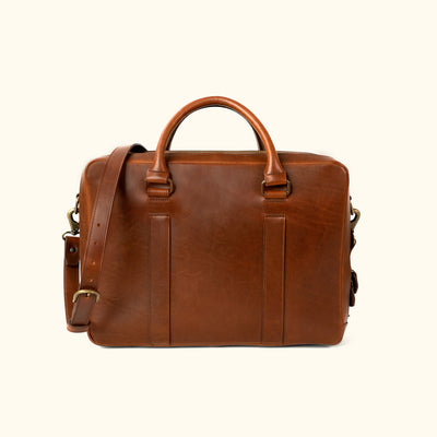 Executive-style tan leather briefcase, featuring a smooth exterior and robust carrying options.