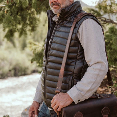 Classic black leather puffer vest, perfect for adding a touch of sophistication to any casual outfit.