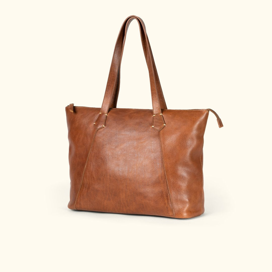 Walker rustic tan leather tote at a three quarter angle showing the full grain leather