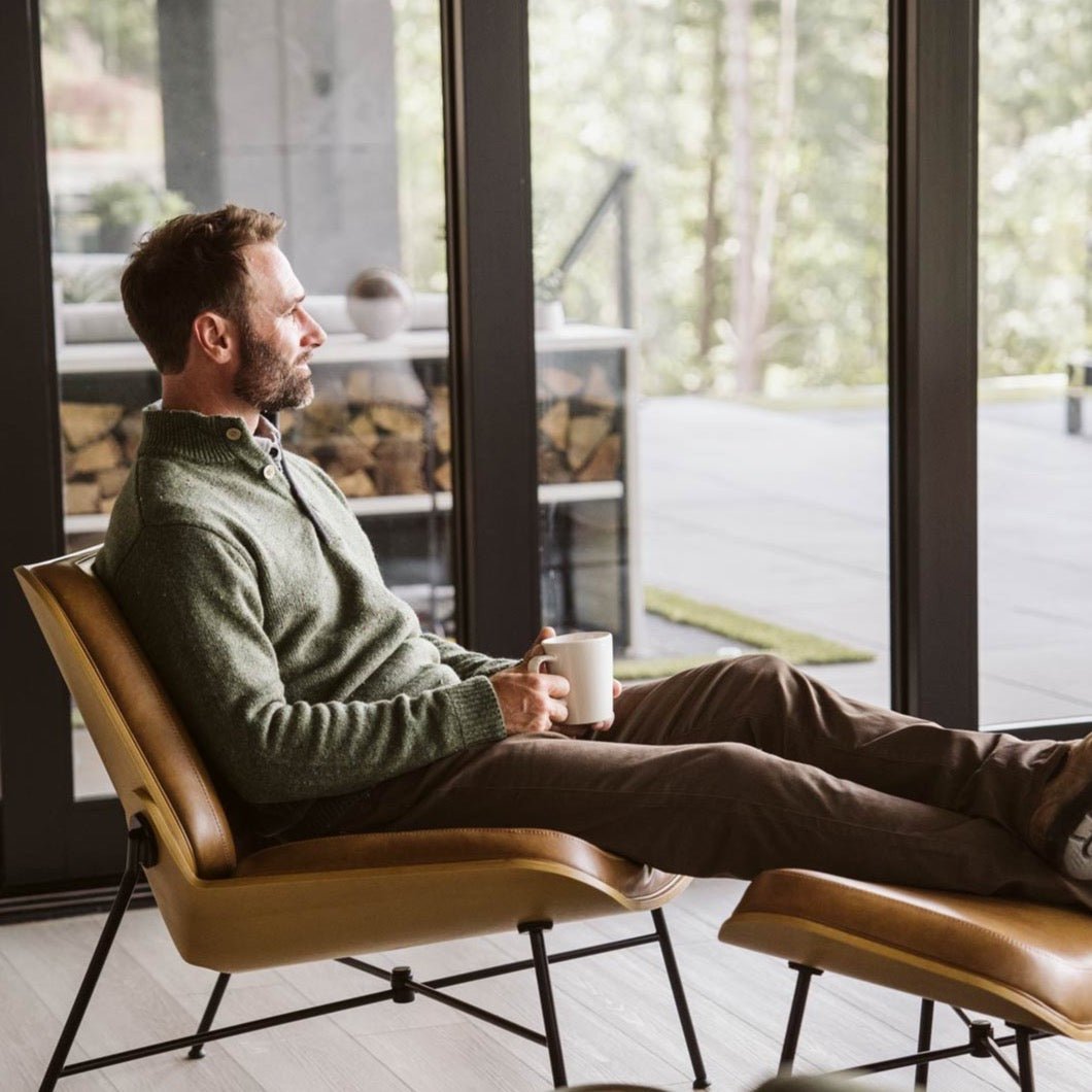 Man in a cabin wearing the Buffalo Jackson Quarter Button Wool Sweater in Pine Fleck