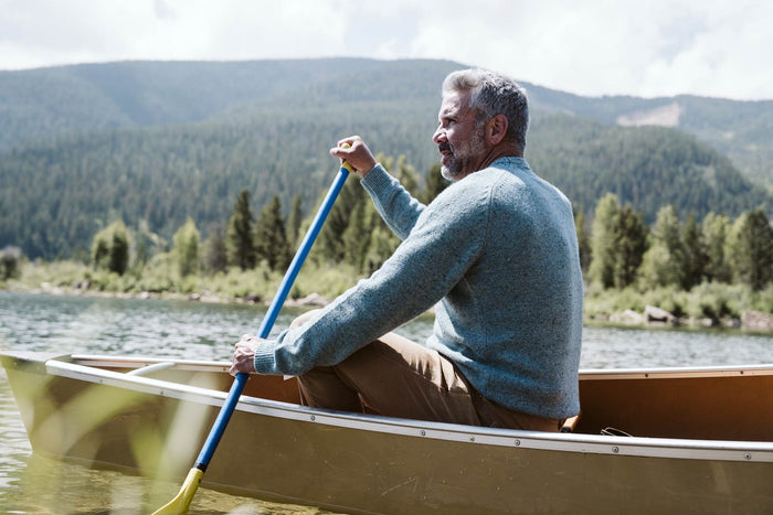 Man outdoors by a canoe wearing the Buffalo Jackson Crewneck Wool Sweater in Sea Fleck