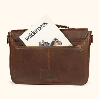 Roosevelt Messenger Bag styled with Wilderness magazine — full-grain buffalo leather laptop bag built for work, travel, and daily carry