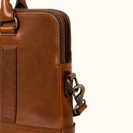 Sleek brown leather attache bag with elegant handles and strap.