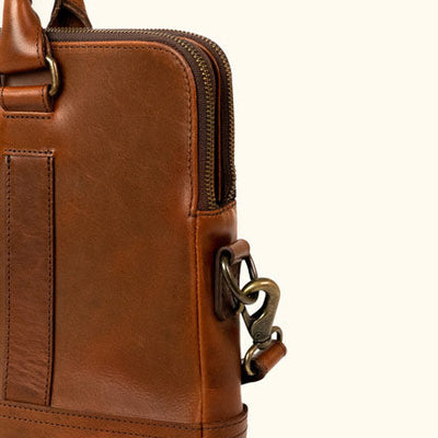 Sleek brown leather attache bag with elegant handles and strap.