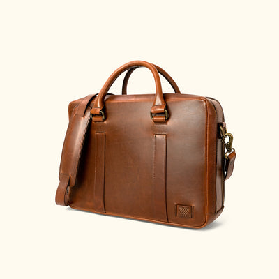 hover Executive-style tan leather briefcase, featuring a smooth exterior and robust carrying options.