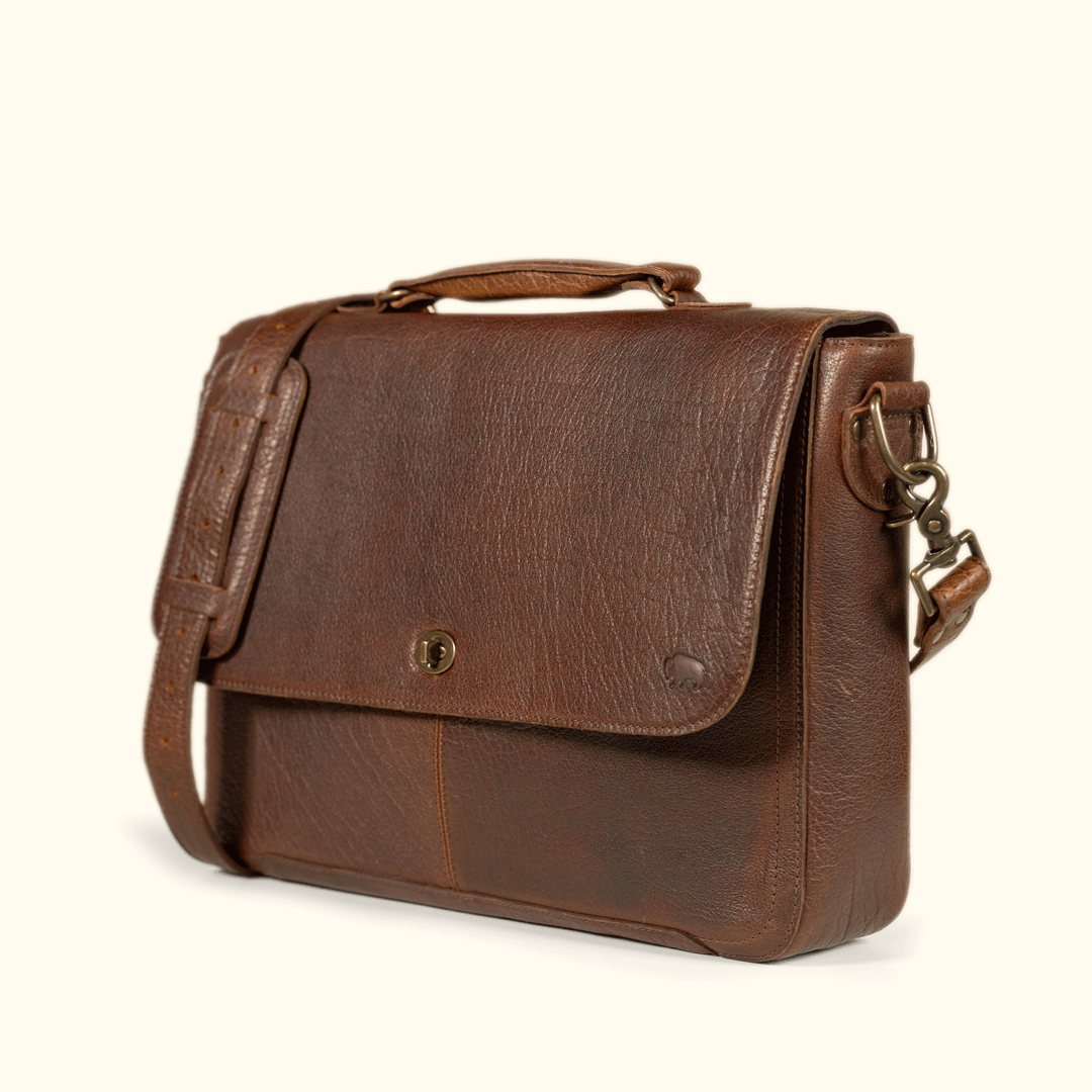 Roosevelt Messenger Bag side profile — gusseted body, cushioned top handle, and vintage postal-inspired silhouette in Buffalo Grain leather