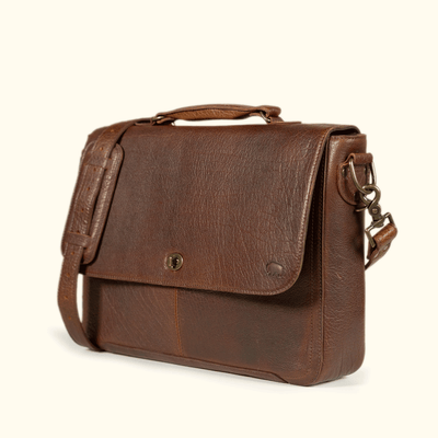 Roosevelt Messenger Bag side profile — gusseted body, cushioned top handle, and vintage postal-inspired silhouette in Buffalo Grain leather