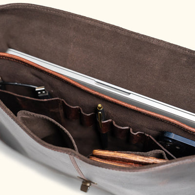 Roosevelt Messenger Bag interior view — two compartments, 15" laptop sleeve, pen holders, Dark Oak suede lining