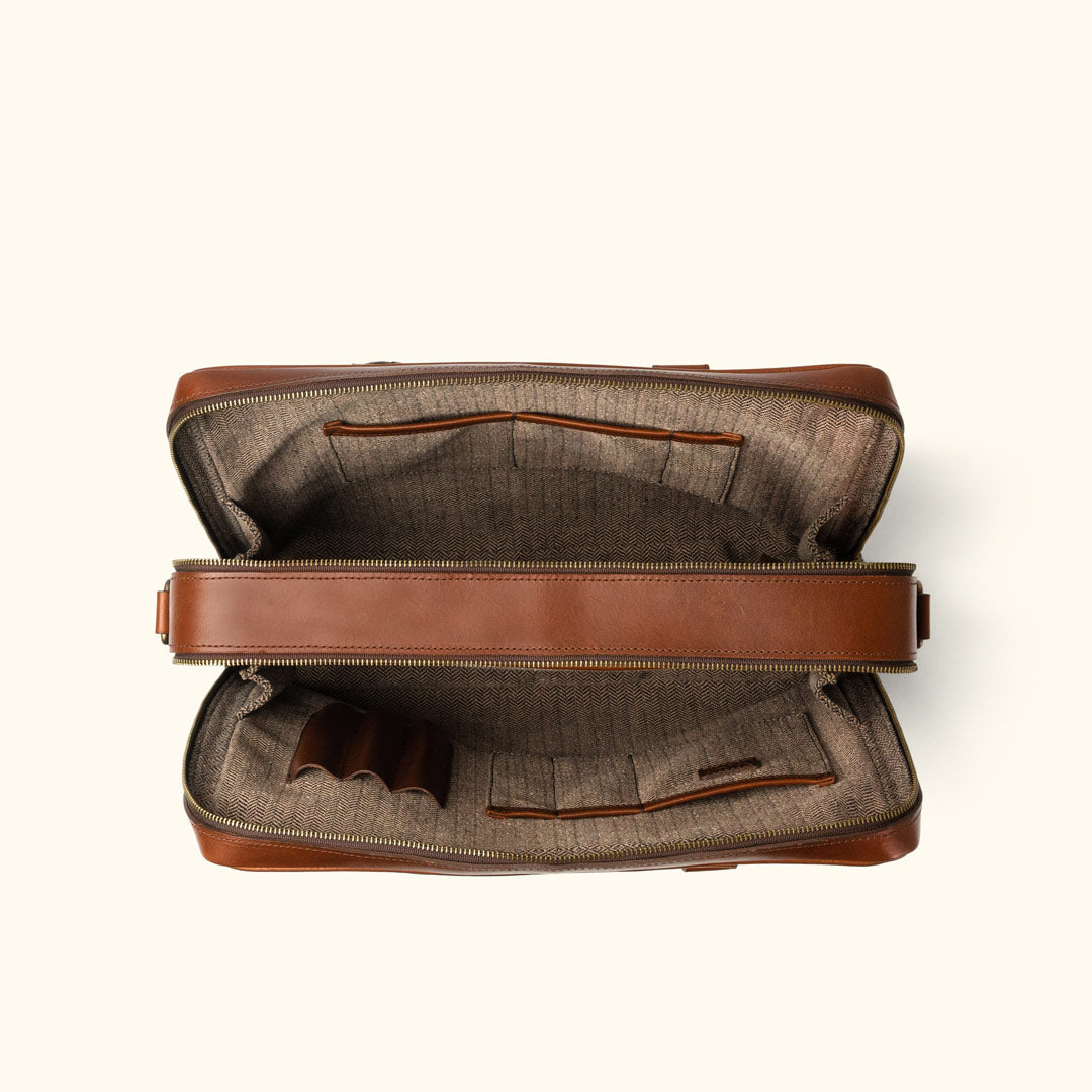 Sophisticated caramel leather briefcase, perfect for business professionals, with a secure zip closure