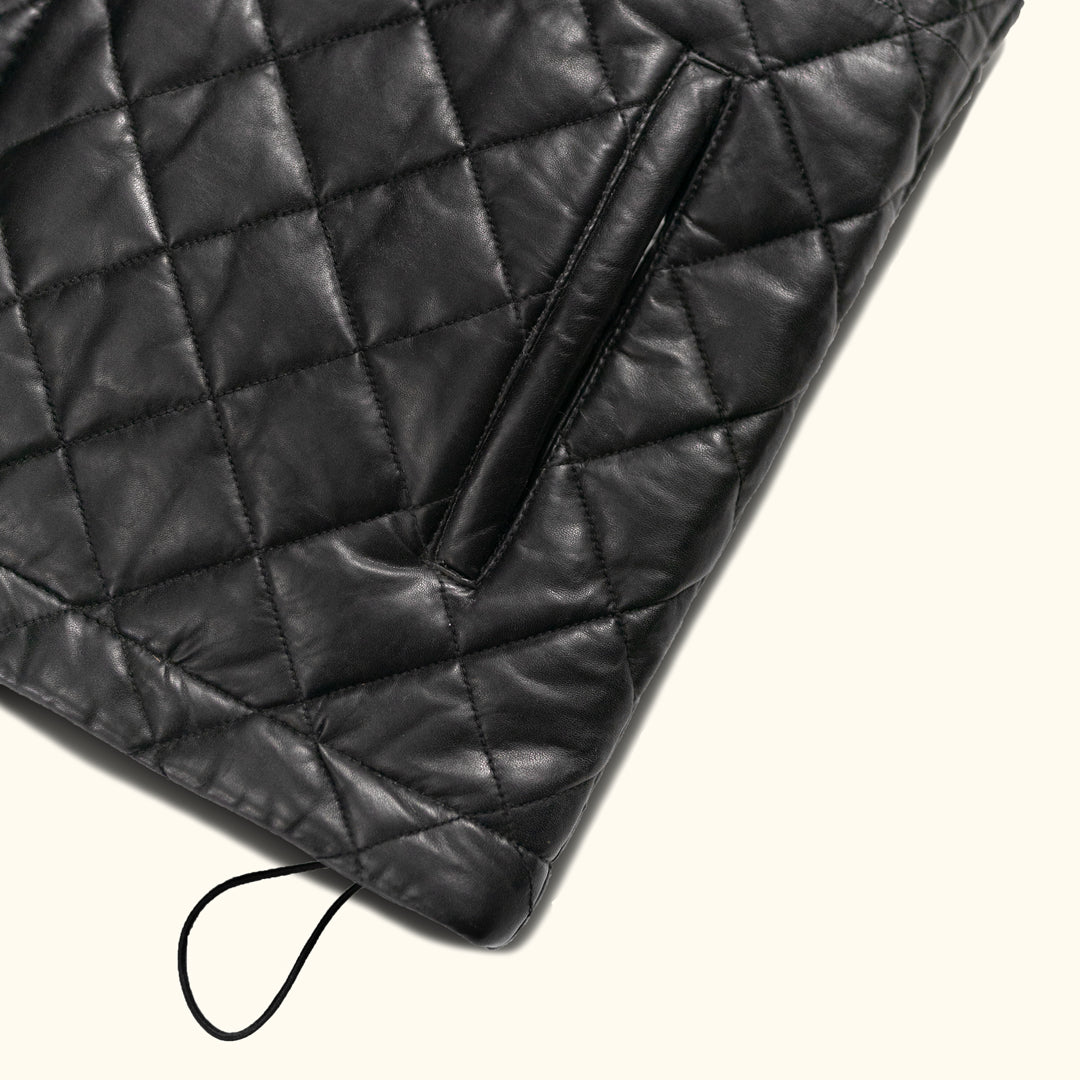 The vest's intricate quilted pattern not only enhances its visual appeal but also provides added warmth and comfort, making it a practical yet stylish choice.