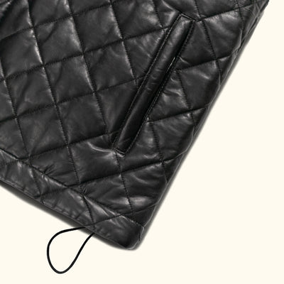 The vest's intricate quilted pattern not only enhances its visual appeal but also provides added warmth and comfort, making it a practical yet stylish choice.