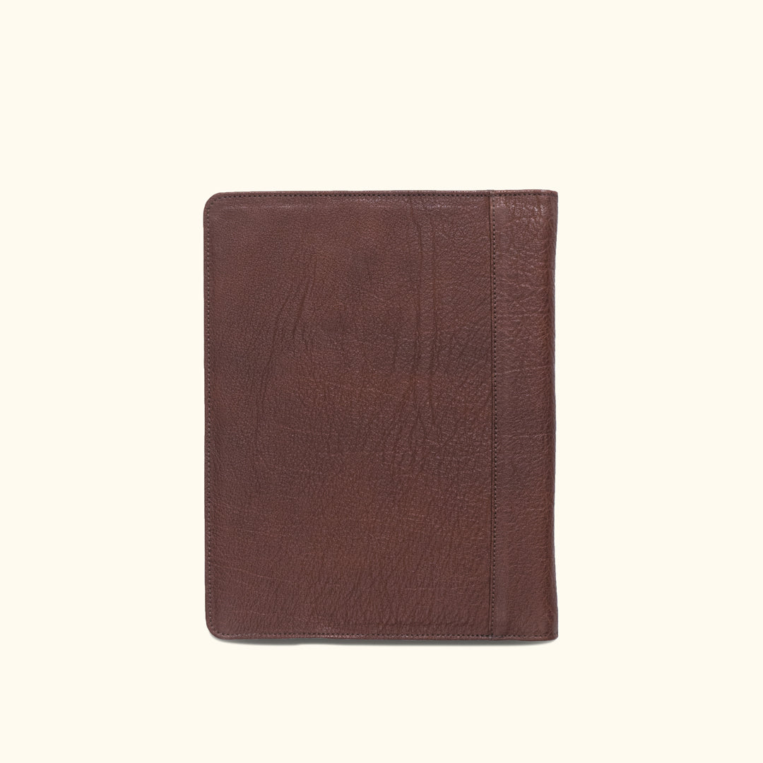 Classic dark buffalo grain leather padfolio, designed for travel with dedicated slots for business essentials.