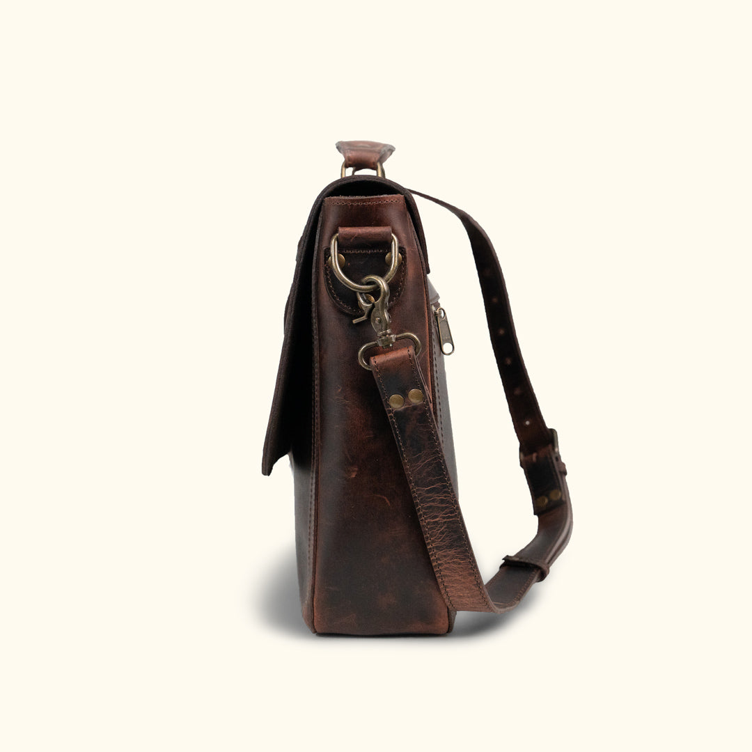 Roosevelt Messenger Bag side angle — Dark Oak full-grain leather, adjustable shoulder strap, multiple storage compartments
