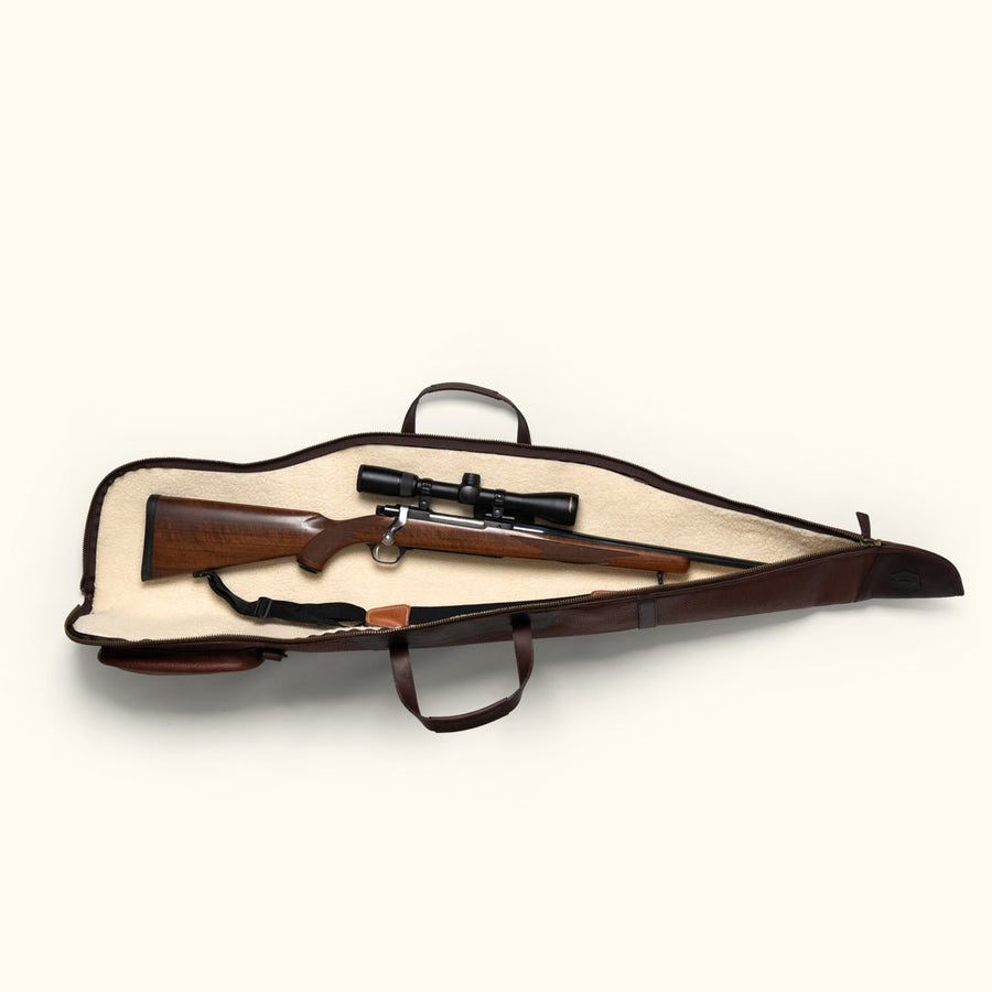 Open leather rifle case showing a scoped rifle inside and the full length zipper running the length of the case