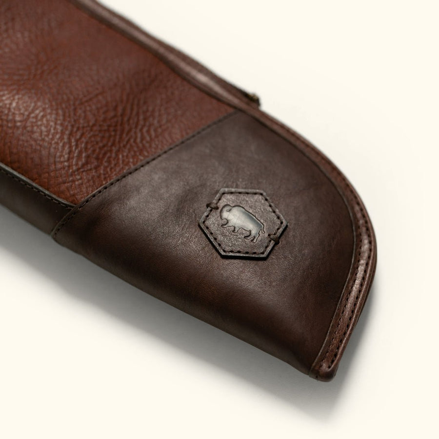 Close detail of the reinforced muzzle end of a full grain leather shotgun case