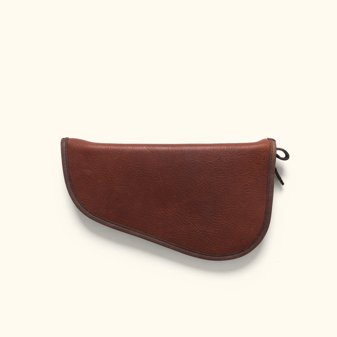Back side of the Dakota leather pistol case showing the vegetable-tanned leather grain and brass zipper