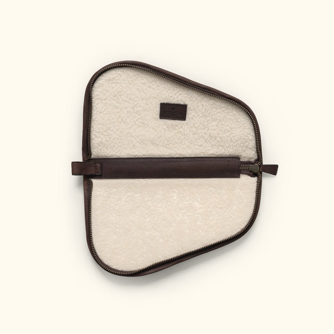 Dakota leather pistol case unzipped and lying flat, showing the thick cream faux shearling lining