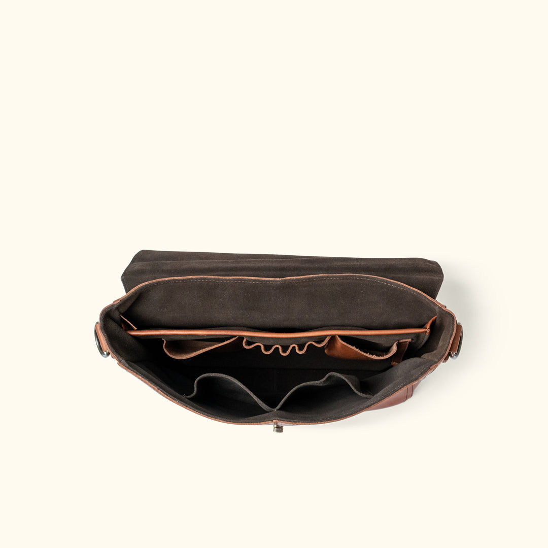 Roosevelt Messenger Bag interior — suede-lined flap, padded laptop sleeve, dual compartments, pen holders, and organizational pockets
