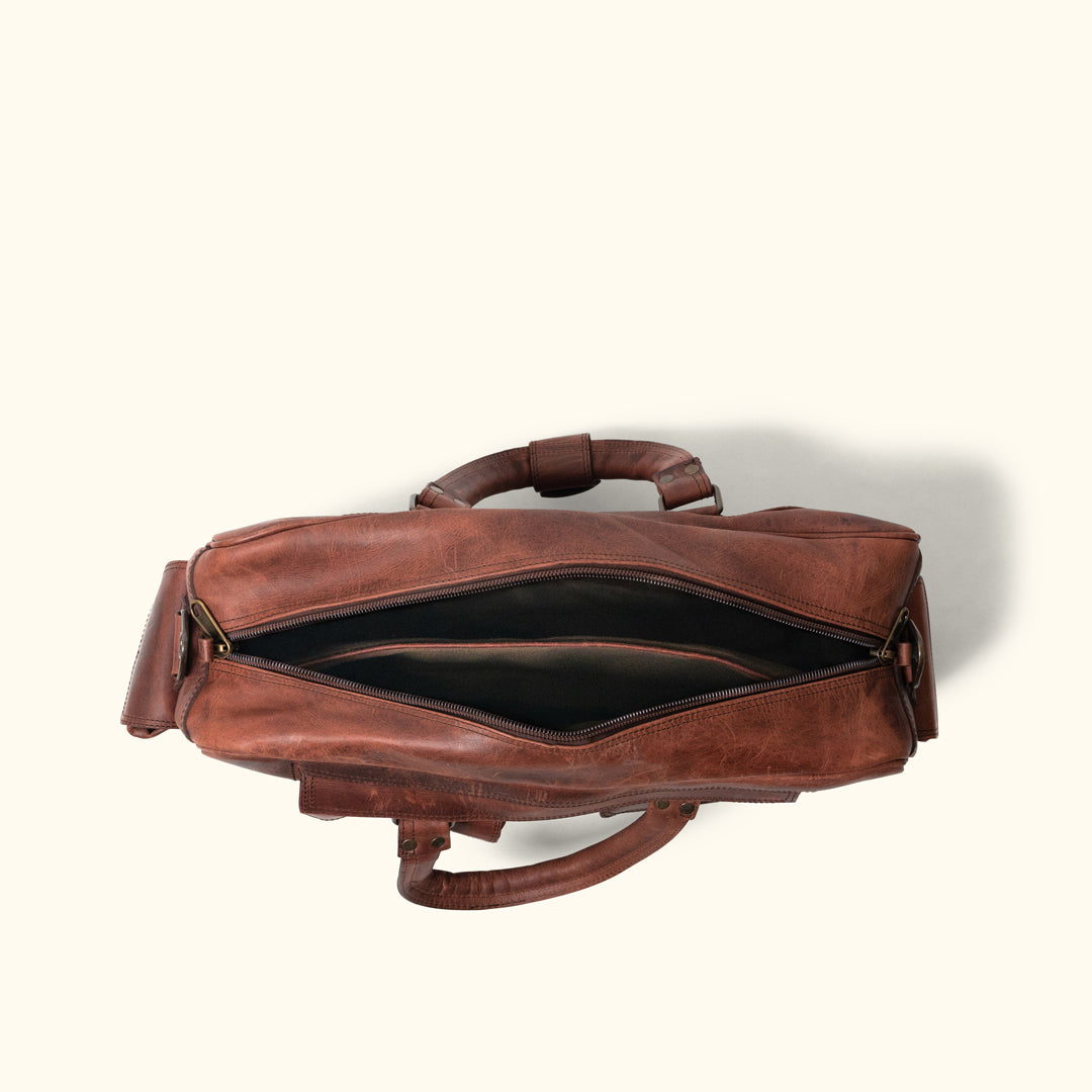 Spacious and stylish Dark Oak leather pilot bag, ideal for business travel, featuring sturdy handles, multiple pockets, and adjustable straps.