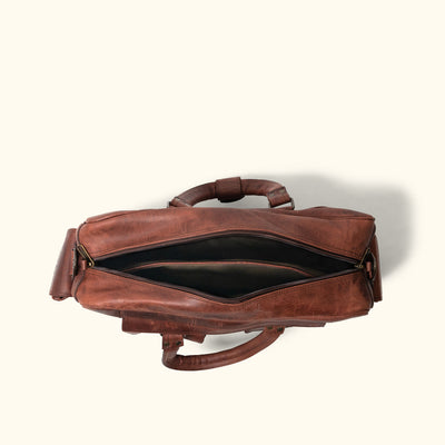 Spacious and stylish Dark Oak leather pilot bag, ideal for business travel, featuring sturdy handles, multiple pockets, and adjustable straps.